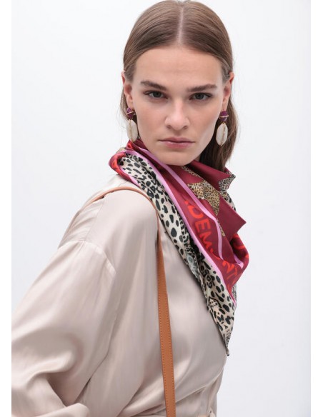 Pañuelo burdeos estampado LC y leopardos de Lola Casademunt - vista del pañuelo en el cuello de una modelo de perfil Pañuelo burdeos estampado LC y leopardos de Lola Casademunt - vista del pañuelo en el cuello de una modelo de perfil
